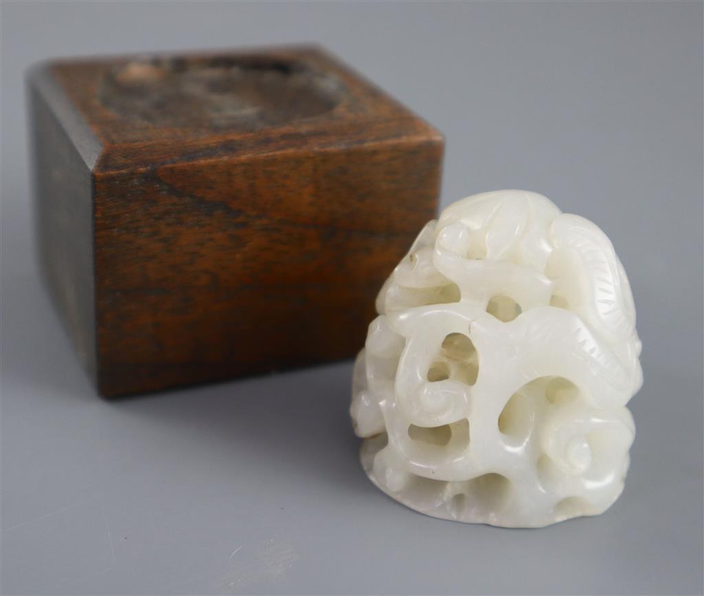 A Chinese white jade hat finial, 3.8cm high, later wood stand